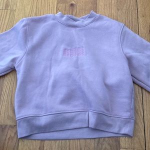 Pink, long sleeve sweater, that's 100% polyster